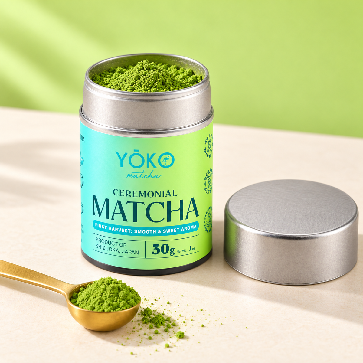 Open Yōko Matcha 30g ceremonial matcha tin with green powder, a deep plain silver lid and gold spoon