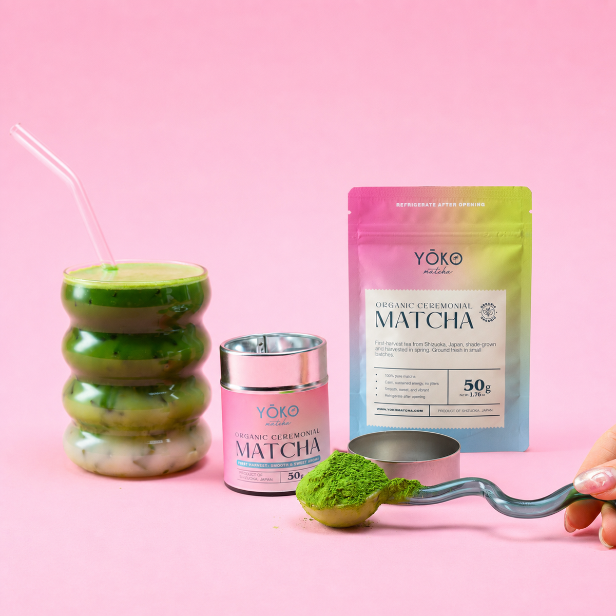 Yoko Matcha 50g pouch and matcha tin styled with an iced matcha drink and scoop of green powder